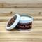 Pumpkin chai scented soy candle in 6oz tin with lid off.