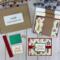 A handmade Christmas card kit with Christmas bulb paper, cardstock, embellishments, ribbons and envelopes to DIY 6 holiday greeting cards.
