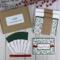 A handmade Happy Holiday card kit with holly scrapbook paper, cardstock, stamped sentiment, ribbon and envelope to DIY 6 Christmas cards.