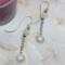 2-inch earrings with platinum sun charms, moonstone beads, and silver ear wires, handcrafted with celestial sparkle
