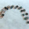Moss agate beads in shades of teal, green and blue are linked by wire wrapping to form a necklace with copper clasp. 