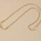Gold-tone vine link pendant with cubic zirconia teardrop charm.