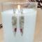 Handmade earrings with opal and quartz stones featuring wire spiral details.