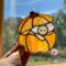Halloween Mouse Suncatcher- in direct sunlight-  made of orange, light brown, light pink and brown glass.