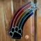 Rainbow Bridge Suncatcher- Black Paw - hanging on a wall.