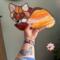 Fox Stained Glass Suncatcher by Robin C. Hary made in shades of red, orange, yellow, cream, and white glass. Being held for size reference.