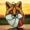 Fox Face Portrait Stained Glass Suncatcher by Robin C. Hary- made of shades of orange, red, and white glass.