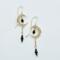 Handmade crescent moon earrings with blue sapphire beads dangling inside moon and on chain underneath