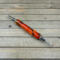 Orange and black resin double ended seam ripper