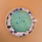 This is a view looking from the top to the bottom of the teacup pincushion/bobbin holder. You can see the pins and the edge of the saucer.