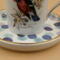 This is a closeup of the saucer and part of the bird on the teacup.  A variety of blues and each has gold trim.