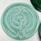 Seafoam Satin: 
Ceramic finger labyrinth in a soft aqua glaze, handmade as a tactile tool for meditation and stress relief. Interior photo. 