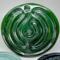 Crushed Velvet:
Deep green ceramic finger labyrinth with a metallic finish, crafted for meditation and calming touch. Interior photo. 