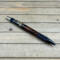 Black anodized aluminum and stainless still resin cast mesquite wood pen