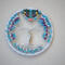 silver yarn wrapped metal hoop cradles wire tree of life. Several color seed beads adorn the branches and roots. Hematite star centers top