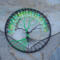 6 inch black yarn wrapped hoop cradles black and green wire tree of life, adorned with black and shades of green frosted glass beads. 