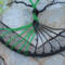 black and green aluminum wire roots attached to yarn wrapped metal hoop