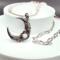 Handmade necklace with silver crescent moon pendant with rose quartz bead set inside a rose. Strung with rose quartz and pink crystal beads.