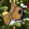 French Bulldog Stained Glass ornament made of tan colored glass, hanging from a Christmas tree with Christmas ornaments and lights around it.