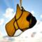 French Bulldog Stained Glass ornament made of tan colored glass,  background is a blue sky with white puffy clouds and bright sunlight.