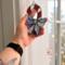 Candy Cane stained glass ornament being held for size reference- approximately 3" by 5"