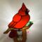 Cardinal Stained Glass Night Light- sitting on a brown glass branch with a green lampworked leaf, cardinal is made of bright red glass.