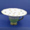 This gives an idea of the size, regular cup and saucer size. It's petite, 6.5 inches wide by 3.5 inches high.