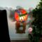 Dragonfly Stained Glass Night Light- in green and blue iridescent glass with yellow, orange mottle glass backdrop. Shown lite.