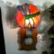 Dragonfly Stained Glass Night Light- in green and blue iridescent glass with yellow, orange mottle glass backdrop. Shown lite.