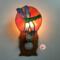 Dragonfly Stained Glass Night Light- in green and blue iridescent glass with yellow, orange mottle glass backdrop. Shown lite.