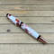 White and copper resin swirled cigar style ballpoint pen