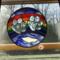10" Rainbow Bridge beveled paw print stained glass panel. Shown in a window for size reference.