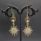 Earrings featuring gold plated star shaped dangles with rhinestones, stainless steel circle and bead accents, 14k gold filled wires.