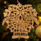 A handcrafted Victorian-style wooden Christmas tree ornament shaped like a basket filled with intricate floral designs, featuring detailed leaves and blossoms, with a small hook at the top for hanging.