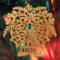 A handcrafted Victorian-style wooden Christmas tree ornament shaped like a basket filled with intricate floral designs, featuring detailed leaves and blossoms, with a small hook at the top for hanging.