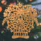 A handcrafted Victorian-style wooden Christmas tree ornament shaped like a basket filled with intricate floral designs, featuring detailed leaves and blossoms, with a small hook at the top for hanging.