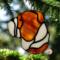 Bulldog stained glass ornament in Fawn shown hanging on a Christmas tree.
