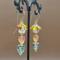 Handmade Czech glass leaf earrings with glass bicones in fall colors on 14k gold-filled wires, about 2 inches long.