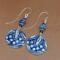 Handmade blue embossed pewter earrings with lapis lazuli beads and glass accents, just over 2 inches long.