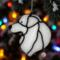 Great Pyrenees stained glass ornament hanging on a Christmas tree.