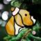 Pit Bull Stained Glass Ornament- shown in tan hanging on a Christmas Tree.