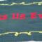 A close up of the words Bless Us Every in the center of the table runner.