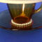 The base of the demitasse cup and saucer with more pearls .