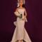 11.5 inch fashion doll wearing white sheath style wedding dress, birdcage veil and holding a bouquet of white lillies