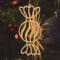 A handmade wooden Christmas tree ornament shaped like a wrapped hard candy, featuring a bulbous center with swirling stripes and twisted wrapper ends, crafted from light-toned wood using a scroll saw.