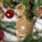 A handcrafted wooden Christmas tree ornament shaped like a wrapped candy, featuring intricate Victorian fretwork with twisted ends and a diagonal swirling stripe in the center.
