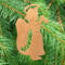 A handmade wooden Christmas ornament in the shape of a cheerful angel, featuring a halo, wings, and a raised arm ringing a bell, hand-cut from solid hardwood and finished with clear shellac.