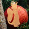 A handmade wooden Christmas ornament in the shape of a cheerful angel, featuring a halo, wings, and a raised arm ringing a bell, hand-cut from solid hardwood and finished with clear shellac.