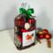 Irish Twins Apple Cinnamon Potpourri bag, green ribbon, next to three apples and cinnamon sticks.