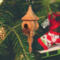 Handcrafted miniature wooden birdhouse ornament shaped like an icecicle with a pointed roof and base, featuring a rounded entrance hole and a perched bird, and made from reclaimed hardwoods finished with a satin shellac.